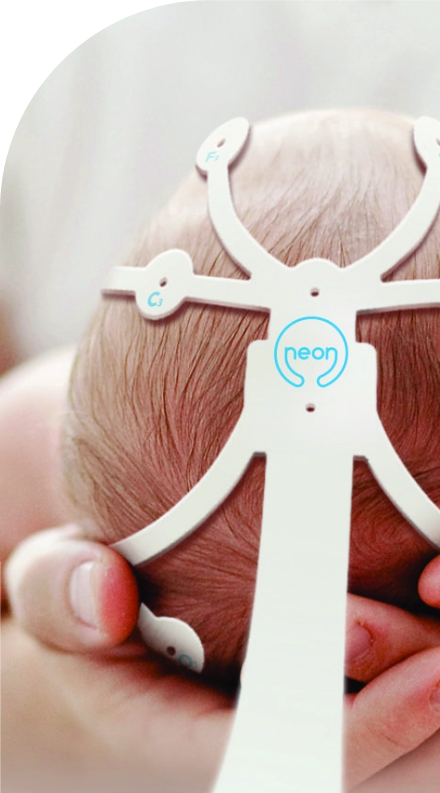 A baby's head is being held up by an electronic device with high quality labels.