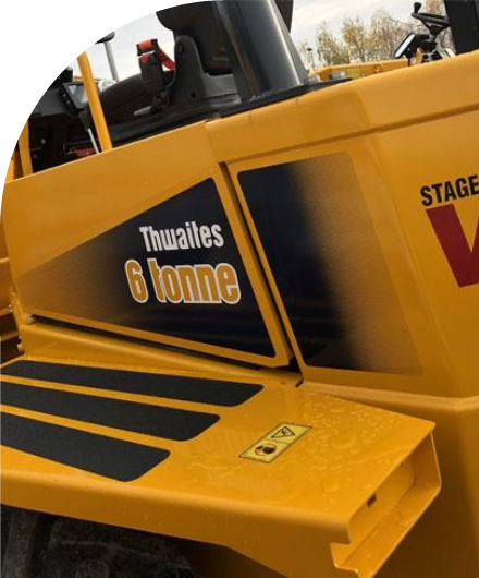 A bulldozer with high quality labels is parked in a parking lot.