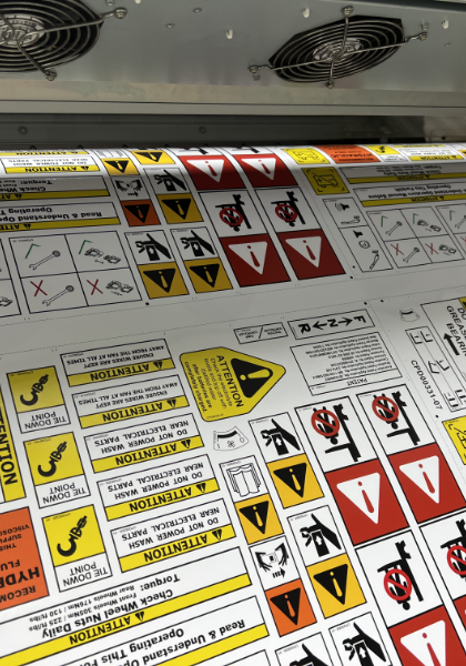 A machine with a large sheet of high quality safety decals.