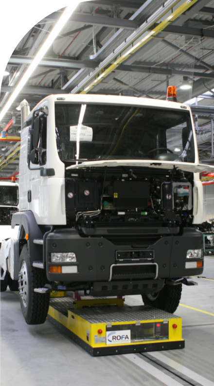 A white truck delivering high quality labels in a factory.