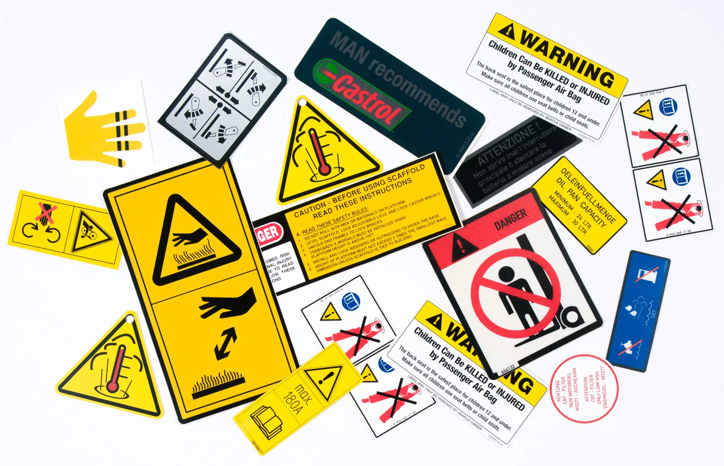 A variety of safety labels and custom decals are arranged on a white background.