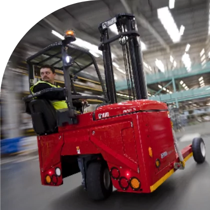 A man operating a fork truck in a warehouse using custom label solutions for medical materials.