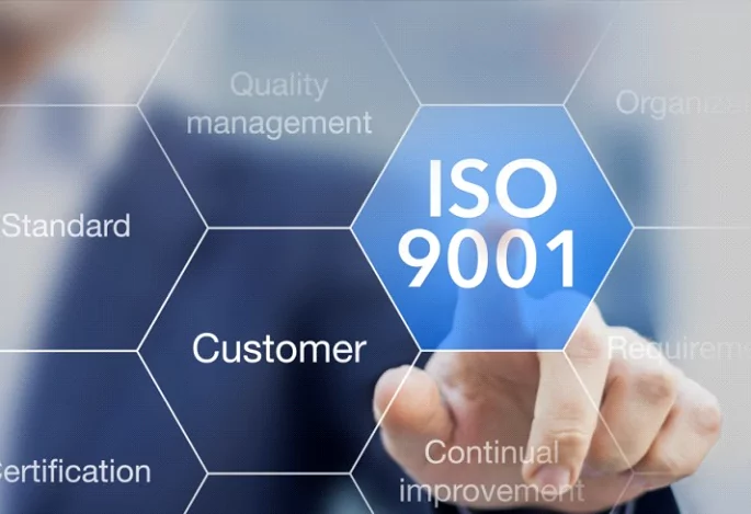 A businessman is pointing to the word iso 9000 on custom label solutions.