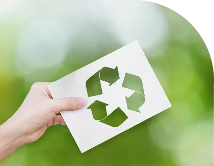 A person holding a paper with a recycling symbol on it.